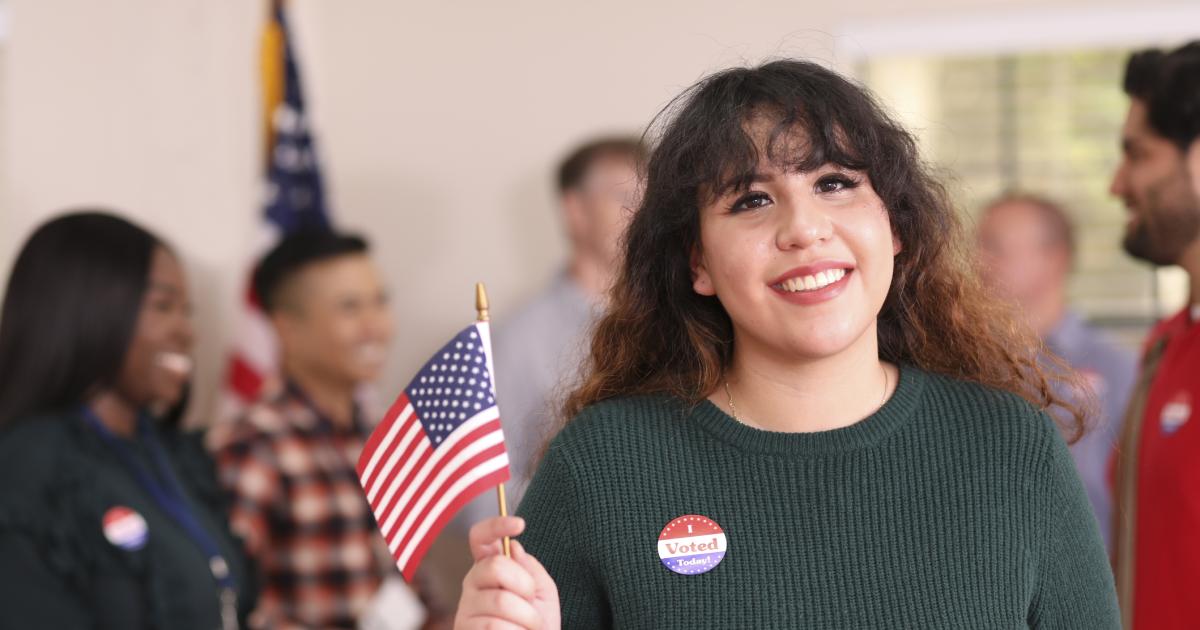 Young adult, Latin descent woman votes in USA election. - stock photo