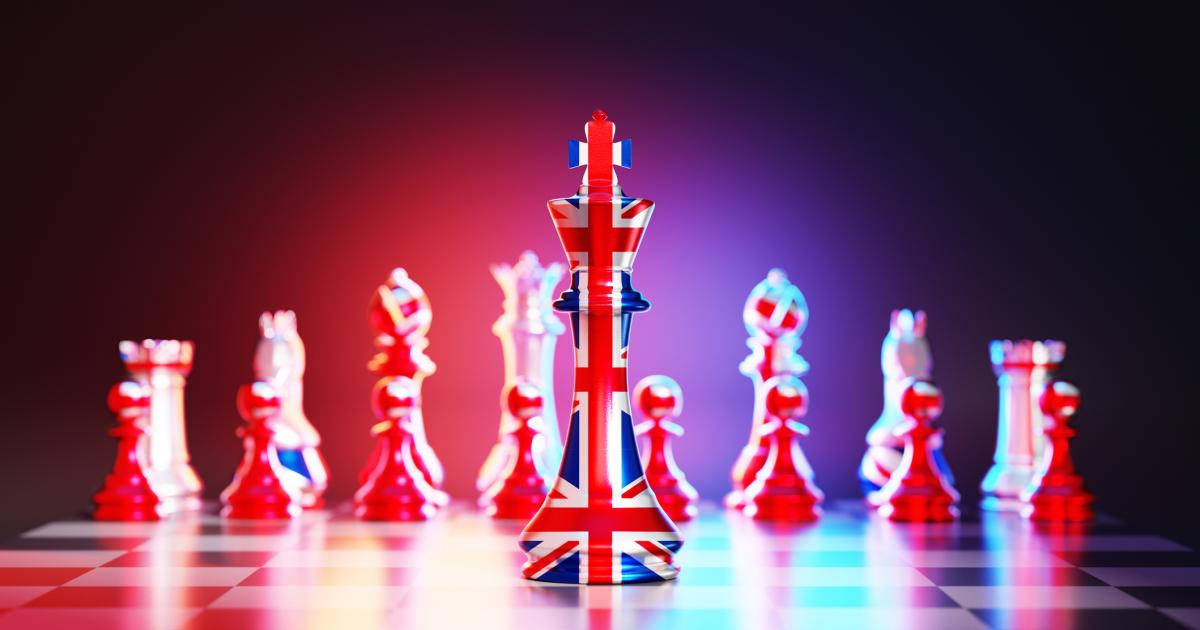 Flag of United Kingdom chess king on a chessboard stock photo